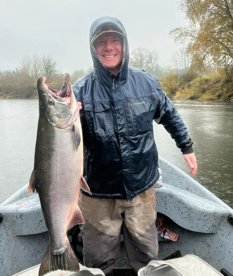Nick smiling while holding a fish